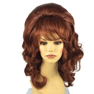 May include: A shoulder-length wig in a rich auburn shade featuring a voluminous bouffant crown, side-swept bangs, and loose, bouncy curls that frame the face. The hair has a smooth, layered texture with a deep reddish-brown color throughout.