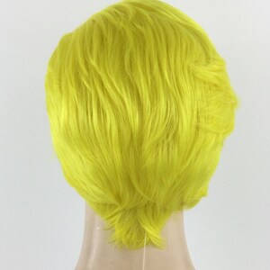 May include: A short, bright yellow wig with a side part and textured layers.