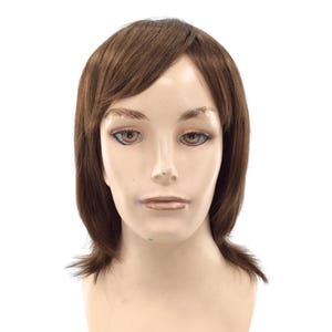 May include: A mannequin head featuring a medium-length, straight brown wig with side-swept bangs. The hair is styled with a slight flip at the ends, framing the face. The mannequin has a neutral expression with painted eyes, eyebrows, and lips.