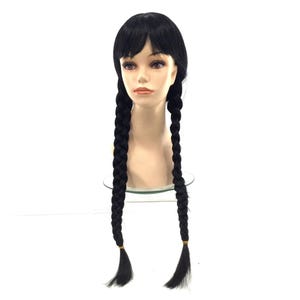 May include: A black wig with bangs and two long, thick braids. The braids are secured with small, yellow-gold elastic bands. The wig is displayed on a mannequin head against a white background.
