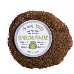 May include: A round container of brown catnip powder with a white label that reads "Meowy Janes All Natural Catnip Alternative Silvervine Powder Contains two natural attractants Highly potent- A pinch is all you need! Gall Fruit Powder".
