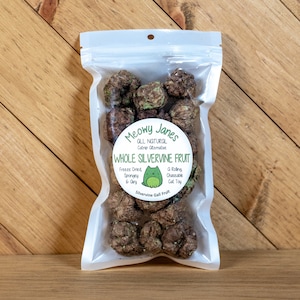 May include: A clear plastic bag filled with brown and green catnip treats. The bag has a white label with the text "Meowy Janes All Natural Catnip Alternative Whole Silvervine Fruit Freeze Dried Spongey & Airy A Rolling Chaseable Cat Toy Silvervine Gall Fruit".