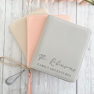 May include: Three different coloured zippered pouches with a wrist strap. The grey pouch has the text "The Robinsons Family Adventures" printed on the front.