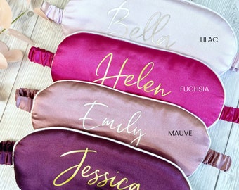 May include: Four satin sleep masks in different colors with names embroidered on them. The colors are lilac, fuchsia, mauve, and mulberry.