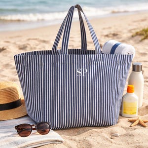 Striped summer bag styled with sunglasses and hat
Personalised holiday tote bag for beach and travel
Large canvas beach bag with striped design