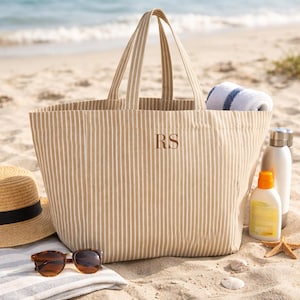 Personalised striped beach bag with initials RS on sandy beach
Large oversized beach tote bag with towel and sunscreen