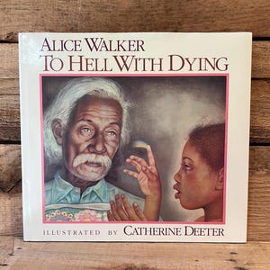 May include: A book cover featuring the title "TO HELL WITH DYING" by Alice Walker, illustrated by Catherine Deeter. The cover art depicts an elderly man with a white mustache and a young girl. The book has a pink border.