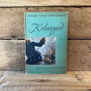 May include: A vintage paperback book titled "Kidnapped" by Robert Louis Stevenson. The cover features an illustration of two men in a dramatic scene, with one pointing a gun at the other. The book is illustrated by William Sharp.