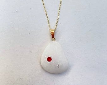 White pebble pendant with Rubi Swarovski crystals embedded. Beach stones jewelry. Diamond gold stone necklace.