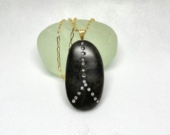Black pebble pendant with 17 Swarovski crystals embedded. Beach stones jewelry. Diamond gold stone necklace.