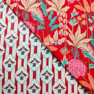 May include: Two fabric swatches with contrasting patterns. One has red and white stripes with floral motifs. The other displays a red floral design with beige, pink, and teal elements. The text "Vinayakamxpeot" is present on the fabric.
