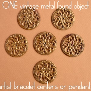 May include: Six gold-toned metal filigree pendants with a floral design.  ONE vintage metal found object artist bracelet centers or pendants.