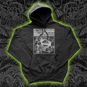 May include: Black hooded sweatshirt with a white graphic. The graphic features the text "FULLY AUTOMATED LUXURY GAY SPACE COMMUNISM" above a black and white illustration of two figures in a spaceship. The hoodie has a front pocket and a drawstring hood.