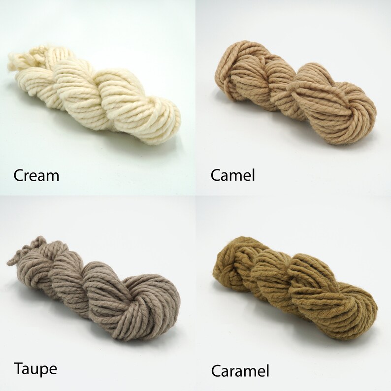 May include: Four skeins of yarn in different shades of brown, cream, and beige. The yarn is arranged in a loose pile, with the ends of the yarn visible. The yarn is labeled with the colors: Cream, Camel, Taupe, and Caramel.