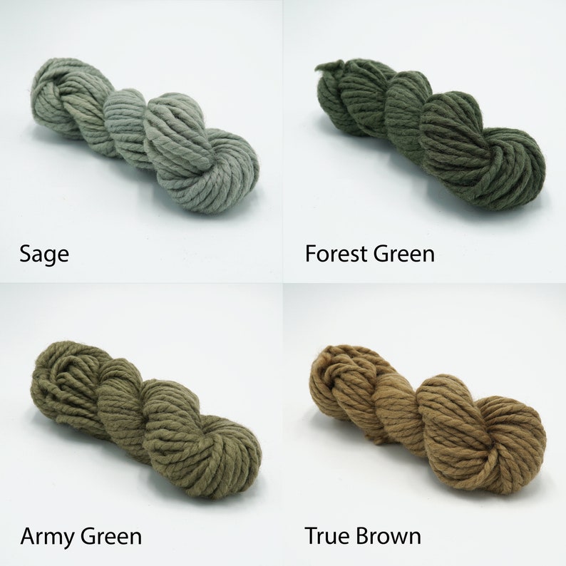 May include: Four skeins of yarn in different shades of green and brown. The yarn is a chunky weight and is made of natural fibers. The colors are Sage, Forest Green, Army Green, and True Brown.