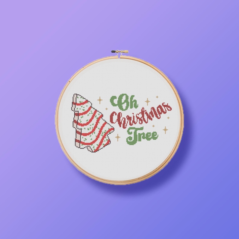 May include: A white embroidery hoop with a red and green Christmas tree design and the text "Oh Christmas Tree".