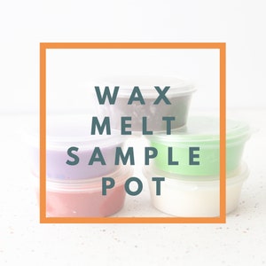 May include: A stack of small, clear plastic containers filled with different coloured wax melts. The containers are labelled "Wax Melt Sample Pot".
