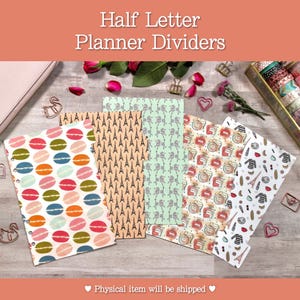 May include: Half letter planner dividers with various patterns, including macarons, Eiffel Towers, and perfume bottles. The dividers are in shades of pink, green, orange, and white. The image also includes washi tape and decorative paper clips.