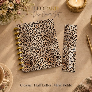 May include: A disc-bound notebook cover and a matching bookmark, both featuring a brown and black leopard print pattern. The notebook cover has gold-colored discs along the left side, and the bookmark includes the white text Today.