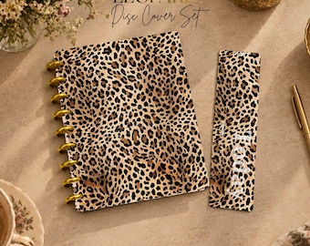May include: A disc-bound notebook cover and a matching bookmark, both featuring a brown and black leopard print pattern. The notebook cover has gold-colored discs along the left side, and the bookmark includes the white text Today.