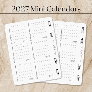 May include: Two white rectangular mini calendar sheets for the year 2027, featuring black text and grid layouts for each month. The text includes the months January through December, the year 2027, and the brand name Planner Sphere Co.