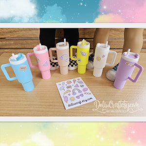 May include: A collection of colorful tumbler cups in blue, pink, tan, yellow, white, and purple, each with a handle and straw. The cups are decorated with stickers featuring various designs. The text "dollscraft.etsy.com" is visible on a sticker sheet and on the surface.
