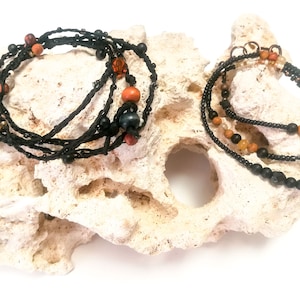 Set consisting of wrap bracelets in different styles, one made of braided leather thread and the other with beads and stones