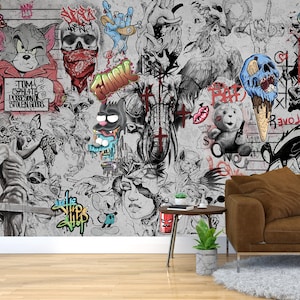 K&ouml;nnte beinhalten: Ein graues und wei&szlig;es Wandbild mit einer Vielzahl von bunten Graffiti-Kunst, darunter eine Comic-Katze, ein Sch&auml;del, ein Comic-Elefant und ein Comic-Eiswaffel. Der Text "TOM 52H416 POSSESSING STOLEN GOODS" ist an der Wand sichtbar.