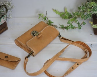 Mobile phone case for shoulder use made of beige vegetable-tanned leather, hand-stitched