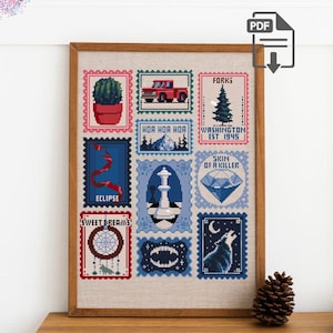 May include: A framed cross-stitch pattern featuring a grid of twelve postage stamp-style designs. The pixel art includes a cactus, a red truck, a pine tree with text reading FORKS WASHINGTON EST 1945, a diamond with SKIN OF A KILLER, and a wolf.