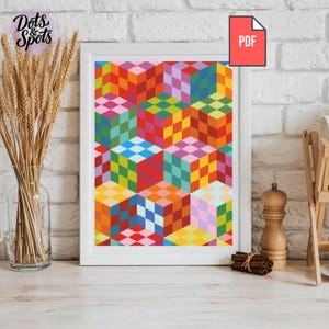 Könnte beinhalten: Ein gerahmter Kunstdruck mit einem farbenfrohen geometrischen Design aus 3D-Würfeln in verschiedenen Farben, darunter Rot, Orange, Gelb, Grün, Blau und Rosa. Der Druck ist mit "PDF" beschriftet und der Markenname "Dots & Spots" ist sichtbar.