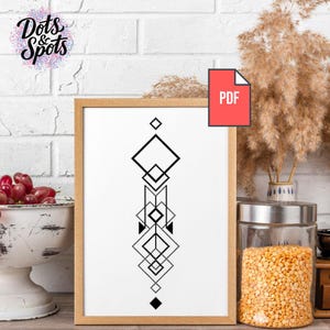 May include: A framed print with a geometric black and white design. The artwork features a series of diamond and square shapes arranged vertically. The frame is a light brown colour. A red PDF icon is in the upper right corner. The Dots & Spots logo is in the upper left corner.