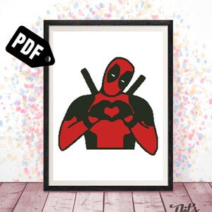 May include: A black and red illustration of Deadpool making a heart shape with his hands. The image is in a white frame with a black border.