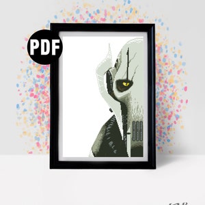 May include: A black and white pixel art cross stitch pattern of a Star Wars character, General Grievous, with a yellow eye. The pattern is framed in a black frame with a PDF label in the top left corner.
