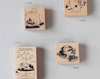 May include: Four wooden stamps with black ink illustrations. The stamps feature a tea bag, a cat, a mountain, and a cup of coffee with a waffle. The text on the stamps reads "红茶包", "记录", "浮山", and "咖啡".