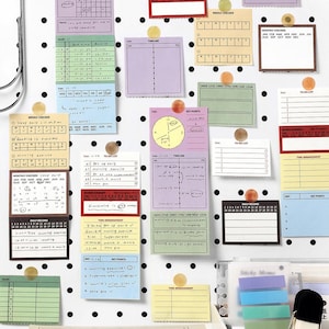May include: A collection of colorful sticky notes and planning cards, including weekly and monthly checkers, timelines, and to-do lists, are displayed on a white pegboard. The notes are secured with small, round, tan push pins. A stack of books is visible at the bottom.