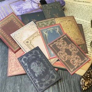 May include: A set of vintage-style decorative paper frames with ornate borders and designs. The frames are in various colors, including brown, red, gold, and blue. They are perfect for scrapbooking, card making, or adding a touch of vintage charm to any project.