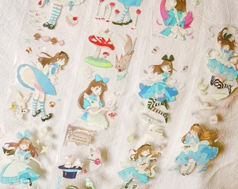 May include: A collection of clear stickers featuring illustrations of Alice in Wonderland characters. The stickers depict Alice in a blue dress, along with other elements like a white rabbit, mushrooms, and playing cards. The stickers are on a white background.