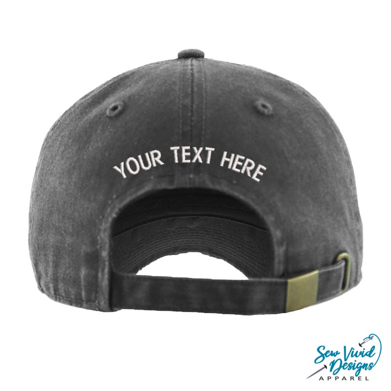 May include: A black baseball cap with an adjustable strap. The back of the cap has white embroidery that says "YOUR TEXT HERE".