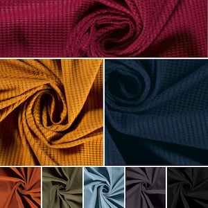 May include: A variety of waffle knit fabrics in different colors, including burgundy, mustard yellow, navy blue, rust orange, olive green, light blue, charcoal gray, and black.