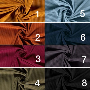 May include: Eight different waffle knit fabric swatches in various colors, including mustard yellow, burnt orange, burgundy, olive green, light blue, navy blue, charcoal gray, and black. Each swatch is numbered 1 through 8.