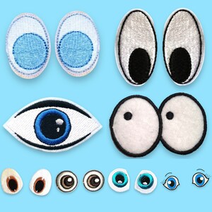 Könnte beinhalten: Eine Sammlung von gestickten Aufnähern mit verschiedenen Augendesigns. Das Set enthält ovale Formen mit blauen oder schwarzen Pupillen, ein realistisches mandelförmiges blaues Auge, runde weiße Augen mit kleinen schwarzen Pupillen und mehrere kleinere Augenpaare.