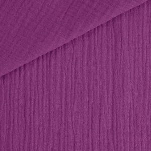 May include: Close-up of a textured, purple fabric. The fabric is folded diagonally, revealing a layered effect. The material has a crinkled, ribbed appearance, with vertical lines running down the surface. The color is a vibrant, deep shade of purple.
