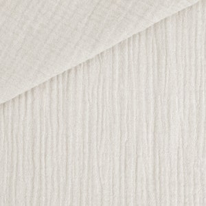 May include: Off-white, textured fabric with a crinkled appearance. The material is folded diagonally, revealing a layered effect. The fabric's surface has vertical, subtle ridges, creating a soft, natural aesthetic. Ideal for textiles and crafting.