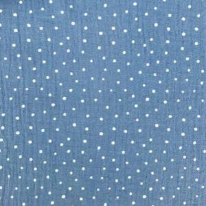 May include: Close-up of a blue fabric with a white polka dot pattern. The fabric has a slightly textured appearance, and the dots are evenly spaced across the surface. The overall effect is a classic and versatile design, suitable for various sewing projects.