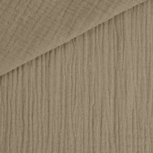 May include: Close-up of a tan-colored fabric with a crinkled texture. The fabric is folded over, revealing a layered effect. The material has a soft, natural appearance, suitable for various textile projects.