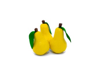 May include: Three yellow pear-shaped ornaments with green leaves.
