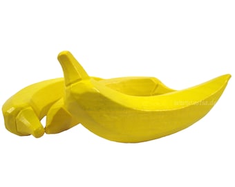 May include: Two yellow wooden bananas, one on top of the other, with a slight curve to the shape.