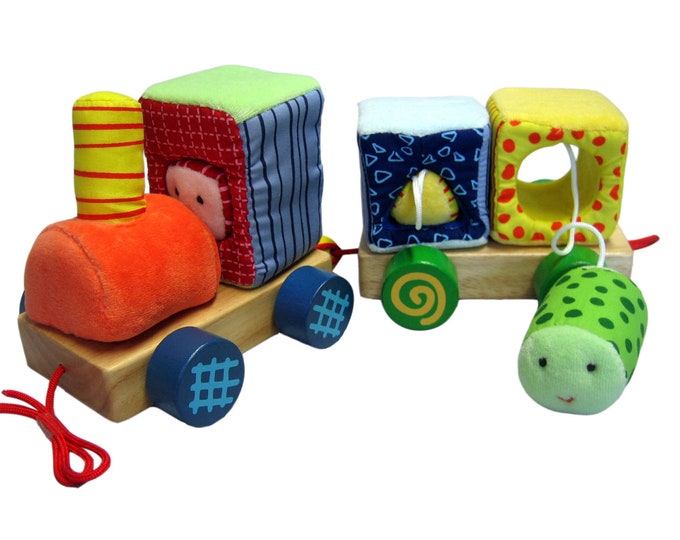 A colorful train made of plush and wood
