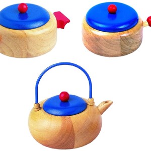 Può includere: Un set di tre giocattoli da cucina in legno: una pentola blu con un manico rosso, una padella blu con un manico rosso e una teiera blu con un manico blu.